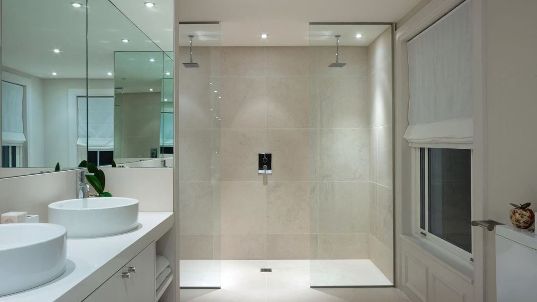 Bathroom with double shower and double basin and white walls