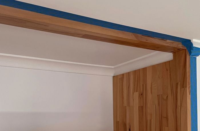 Blue masking tape around varnished timber
