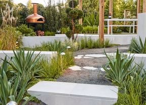 A diverse mix of materials including rocks, brick and stone pavers in a garden