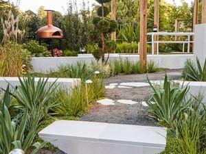 A diverse mix of materials including rocks, brick and stone pavers in a garden