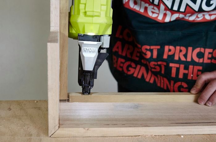 Beading being attached to a dog bed frame using a nailgun