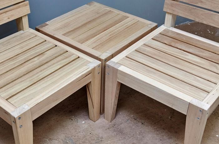 A completed modular wooden outdoor furniture set, composed of two chairs and a coffee table