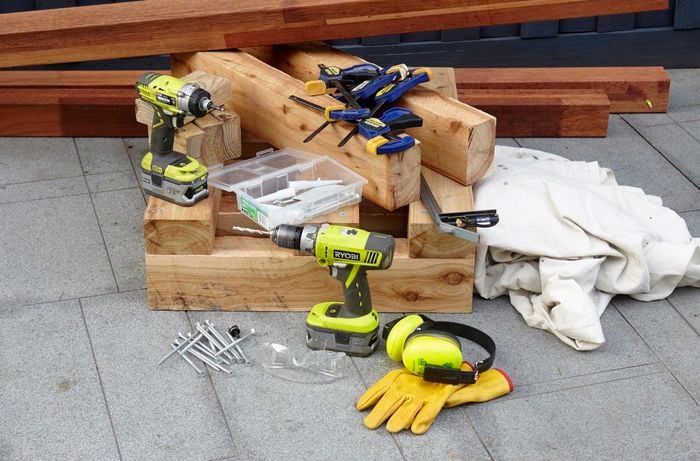 Several lengths of wood, power drills, bolts, clamps, a square rule, gloves and earmuffs