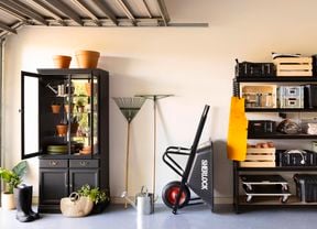 Organised garage with shelving and cabinet.