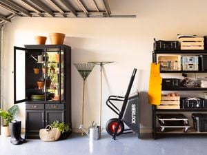 Organised garage with shelving and cabinet.