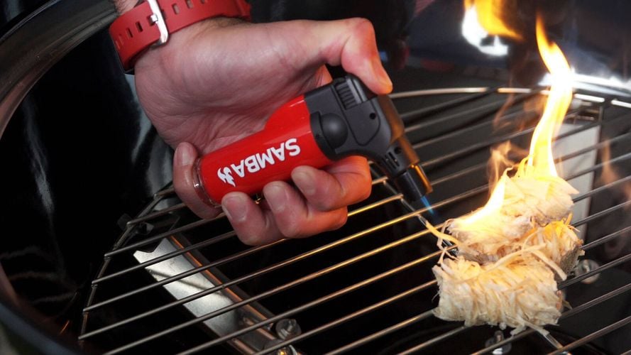 Samba Jet Flame Torch lighting up BBQ Firestarters on BBQ grill
