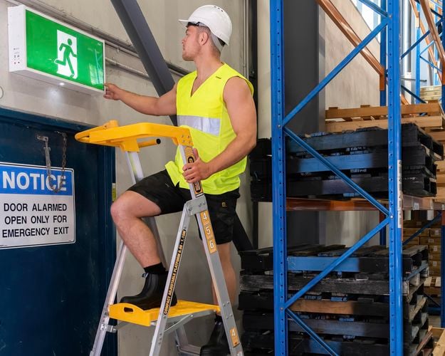 tradesperson working on a ladder
