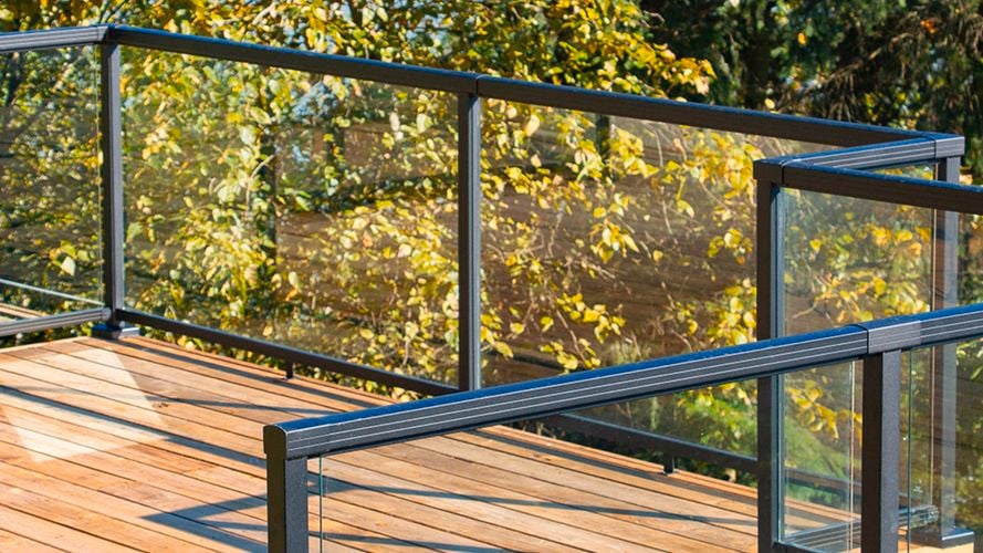 Balcony area with black aluminium balustrade and glass panels.