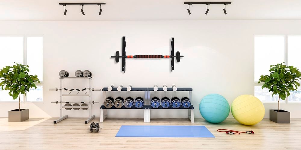 A room full of gym equipment stored in barbel holders.