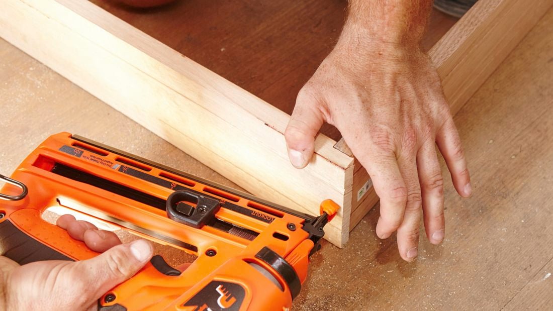 A joints of a wooden frame being secured with a nail gun