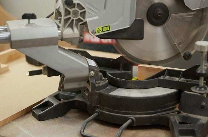 Person using drop saw to cut timber