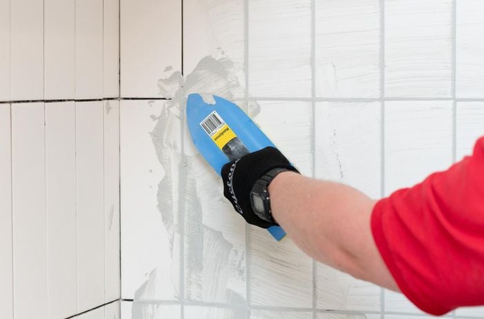 applying grout to the tiled area