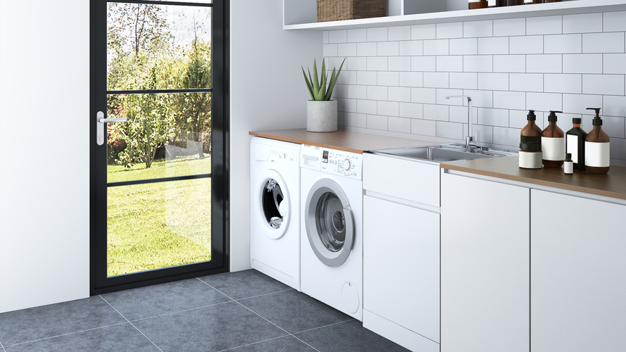 laundry room with machine, cabinets