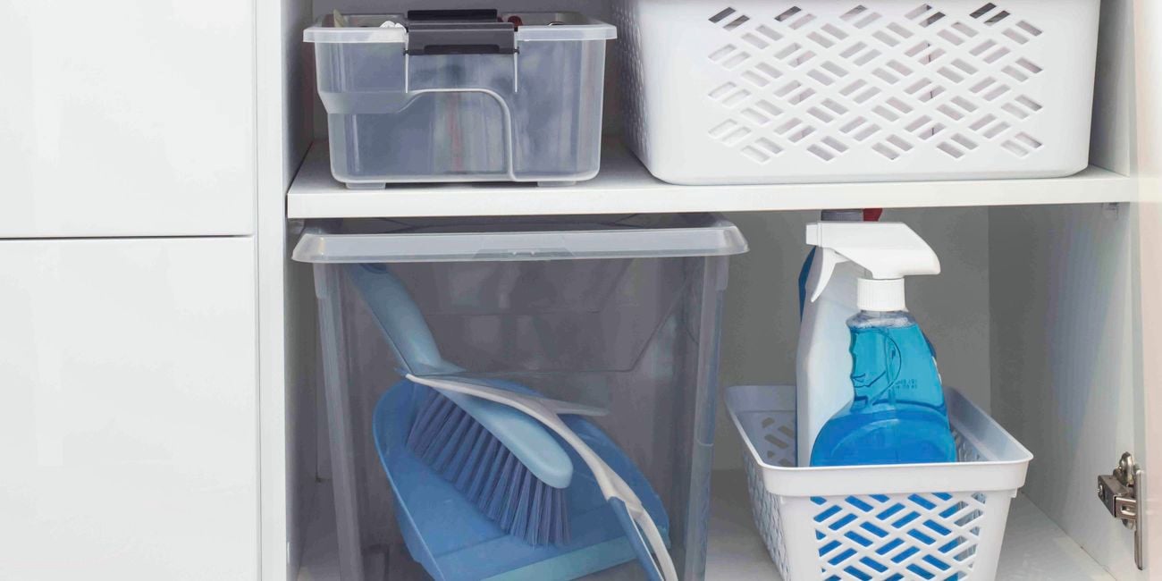 Laundry cupboard open with storage containers