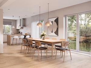 A spacious modern dining area with hanging lights near a kitchen