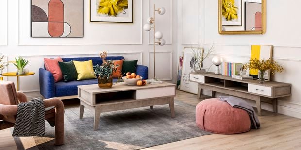Bold living room with wall prints and mixed furnishings.