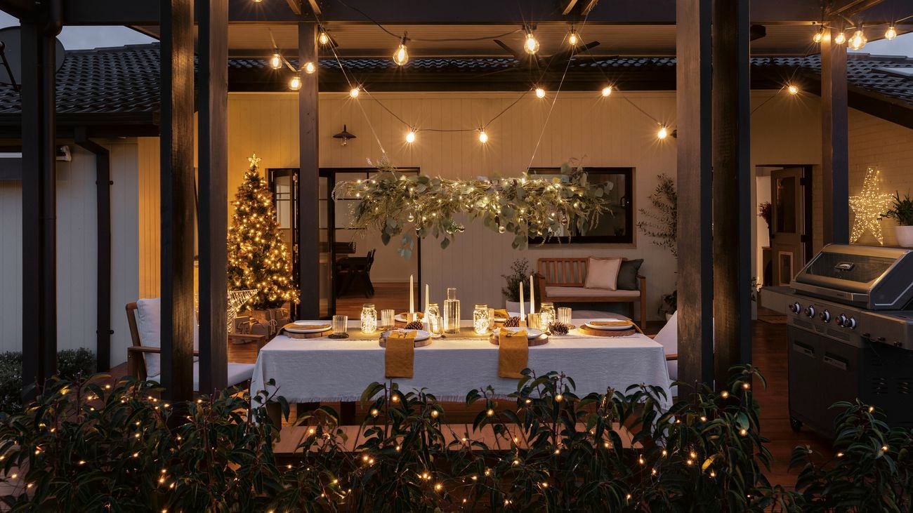 A Christmas chandelier above a table setting