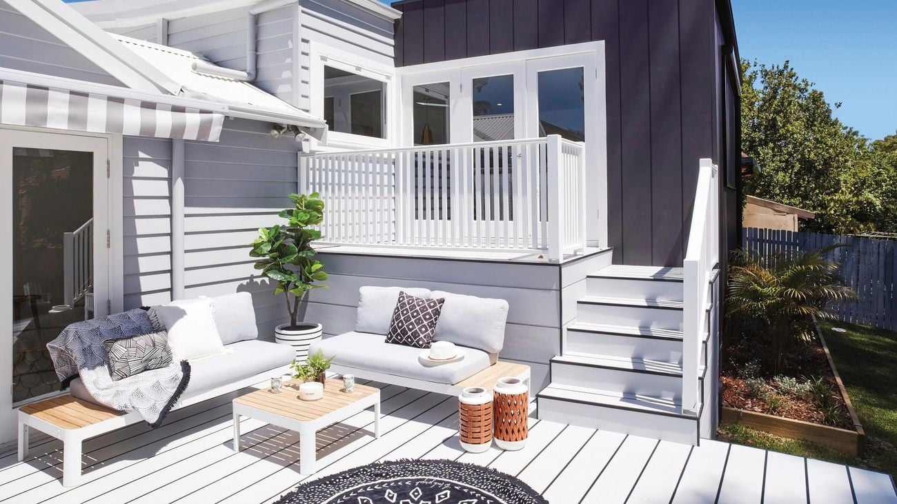 Outdoor area with white non-timber decking and coastal looking furniture.