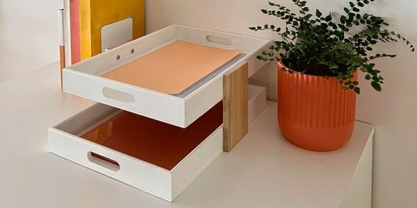 Complete timber desktop paper tray with pot plant and books on desk.