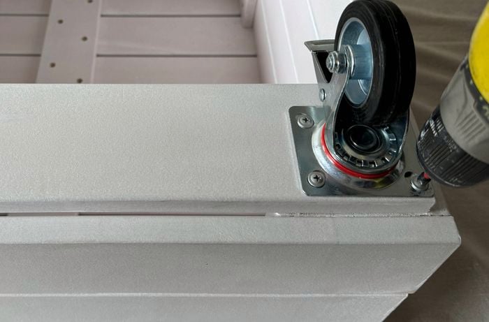 Castors added to the corner of a planter bench