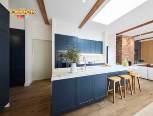 Kitchen with navy island, marble top, wooden stools, and open-plan living.