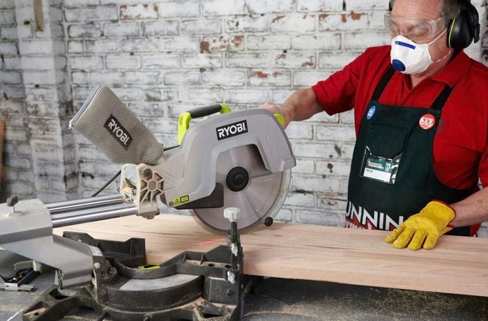 A mitre saw being used to cut a length of timber for a bar counter