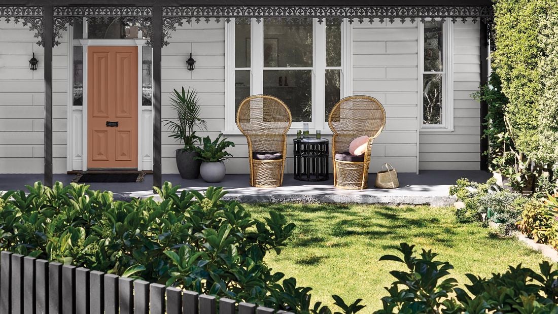 Front of a house featuring lawn front yard area and outdoor dining furniture.