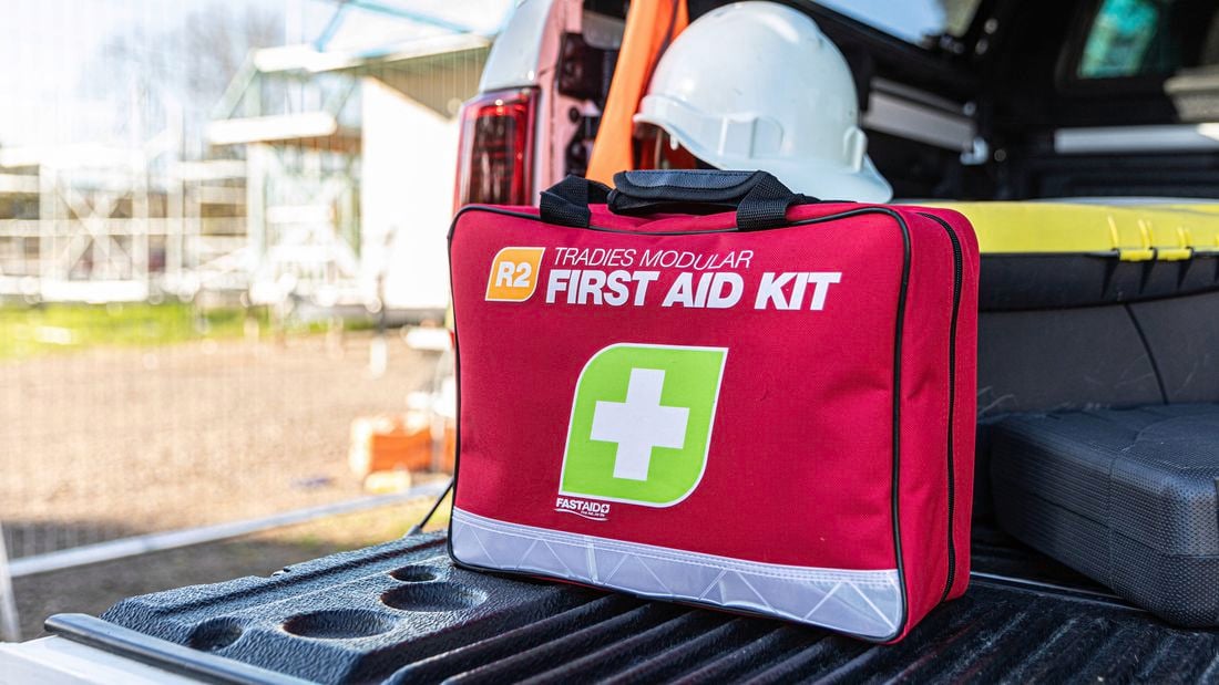 Fast aid kit next to a car ready to use if needed