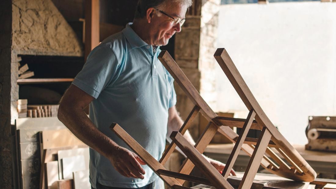 Man looking at timber chair legs