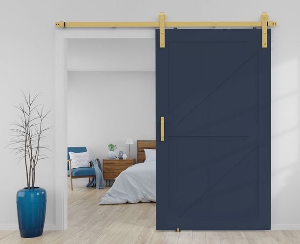 Bedroom interior featuring Rolltrak Brushed Brass Side Mount Barn Door Track, Brushed Brass Square Raised Handle and Brushed Brass Barn Door Floor Guide.