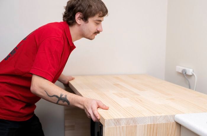 Positioning a timber laundry bench over the washing machine and dryer