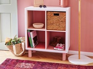 Completed cube unit with pink shelves and hat rack standing beside.
