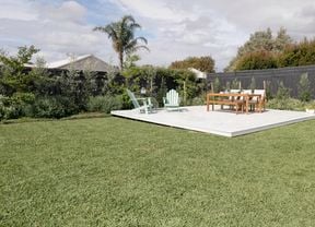 Sprawling green lawn with outdoor furniture.