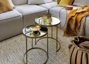 Light grey couch with mustard cushions and throw blanket.