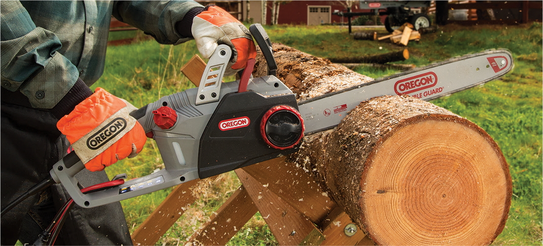 Person using chainsaw to cut through log