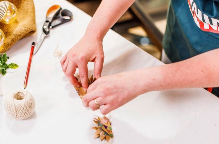 Glue the cut outs onto the string