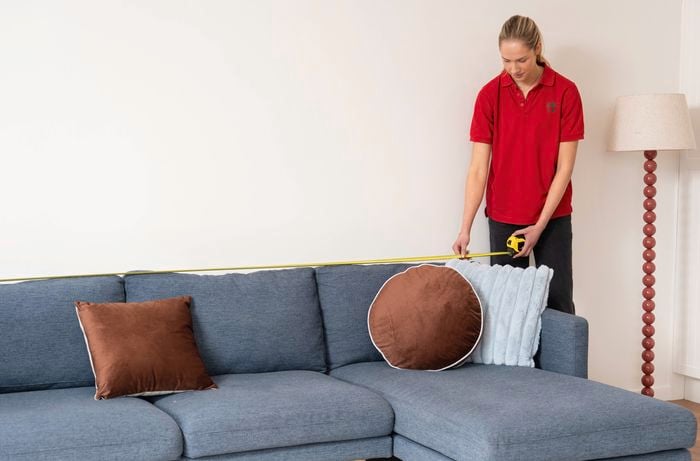 A person is measuring the space for shelf project