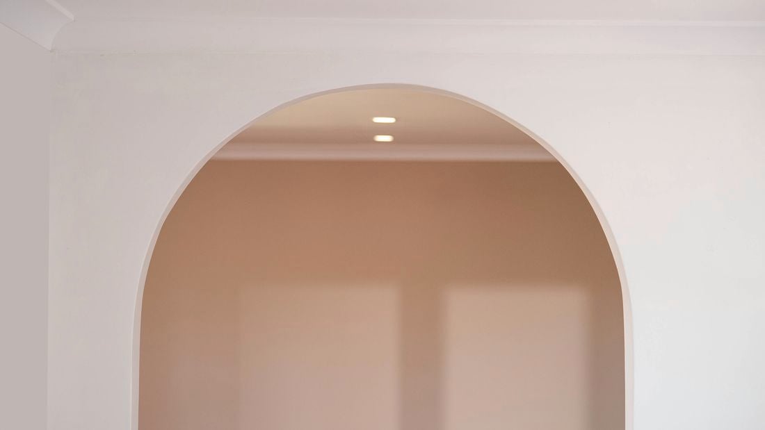 A smooth white plaster arch.