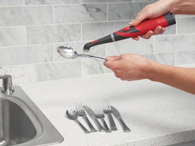Power Scrubber cleaning cutlery.
