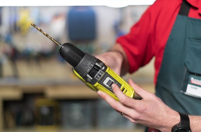 Team member showing the controls on a power drill