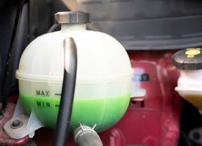 Car coolant reservoir is filled with green coolant