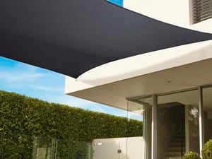 Shade sail attached to a roof of a house