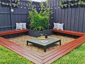 Outdoor seating area with plants and timber fencing
