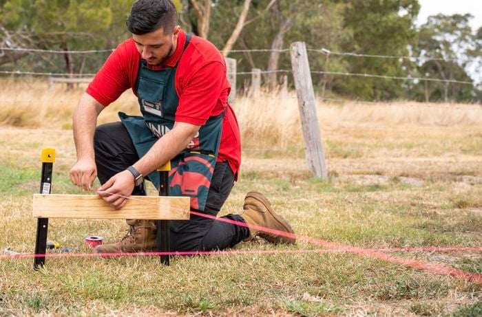 Man running the string line to create shape of deck.