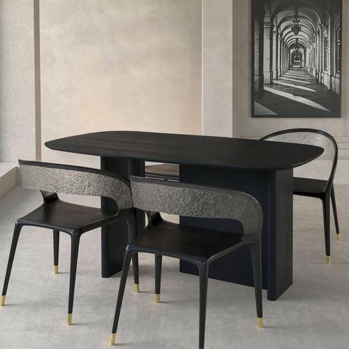 Bold and sculptural, this black oak table features a smooth curved top and geometric base for a modern statement. I/N: 0684327