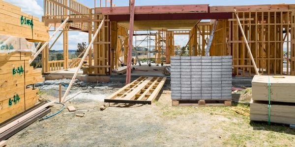 Scaffolding in front of a building under construction, using OSB wall panels