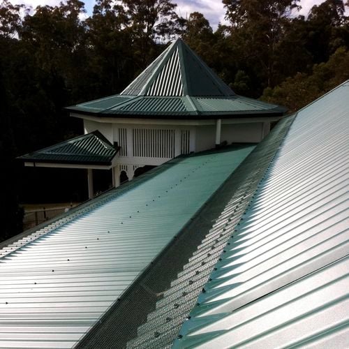Green colour roof with an installed gutter mesh.