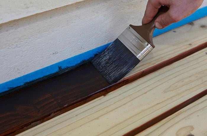 DIY - Step 2 - Stain edges and corners with paint brush - How to stain a deck