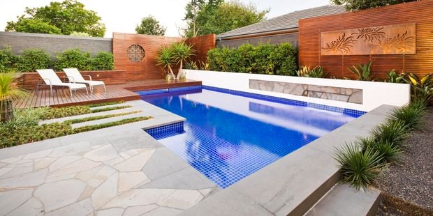 Pool with decking, timber decorative screening and concrete edging