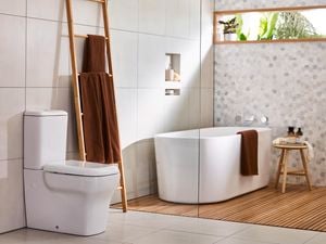 Bathroom with toilet, bath and towel rail